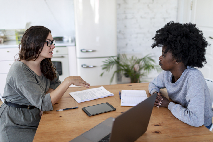 A financial advisor explaining to a client how progressive taxes will impact her finances.
